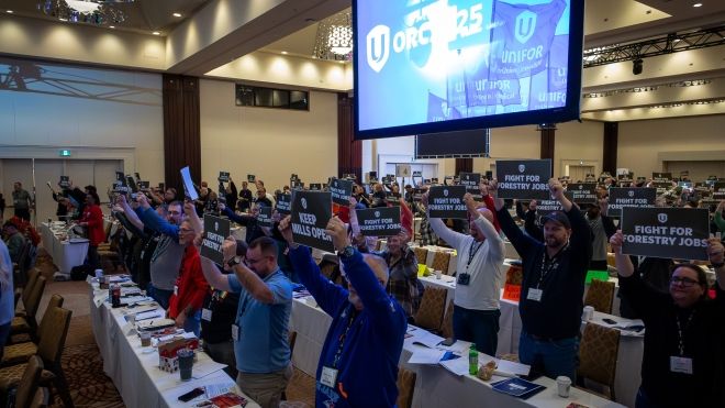Conference room full of delegates and ORC on a screen above.