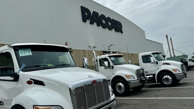 Exterior PACCAR building with trucks parked outside