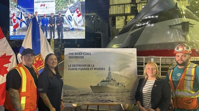 Atlantic Regional Director Jennifer Murray stands with MWF Local 1 members in the Halifax Shipyard