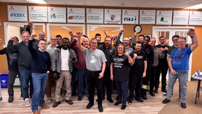 A large group with fists raised