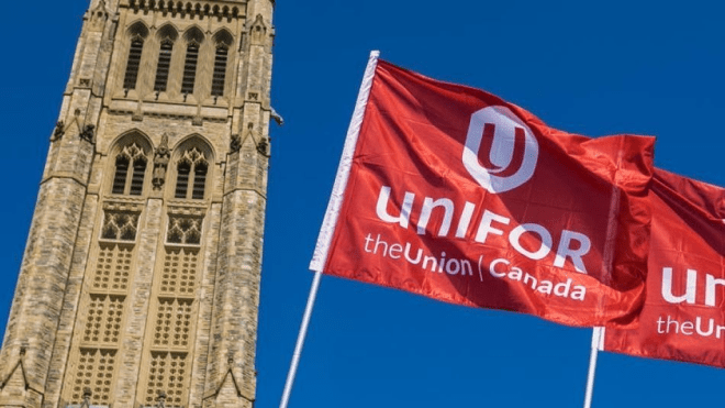 Unifor flag flying in front of Parliament Hill.
