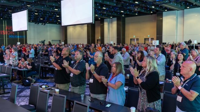 Unifor BWP delegates clapping. 