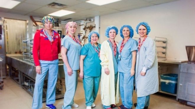 six health care workers wearing scrubs and PPE