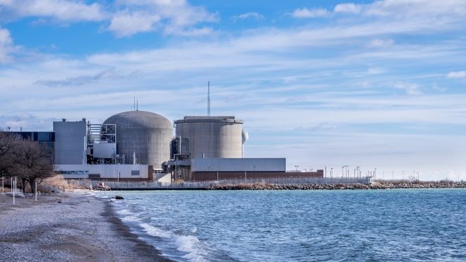 Nuclear facility with a shoreline in the foreground.