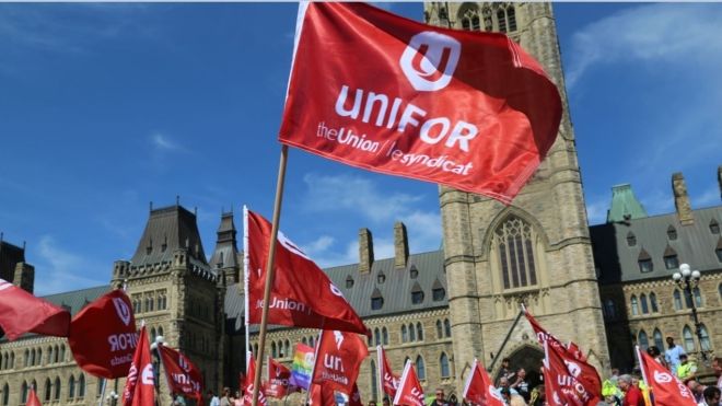 Unifor flags in front of Parliament buildings in Ottawa.