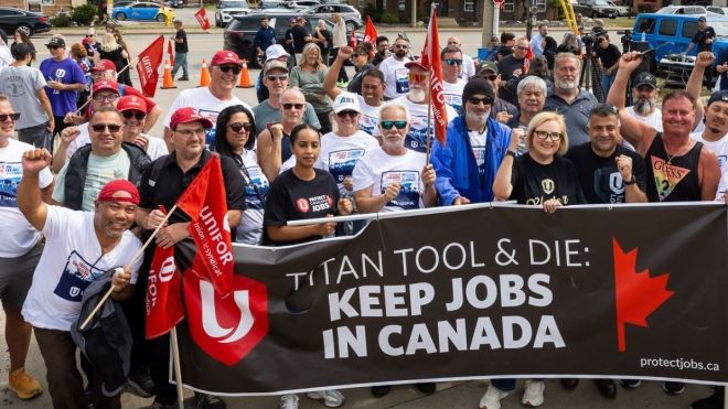 group of people holding rally banner 