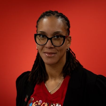 A women's headshot on a red background