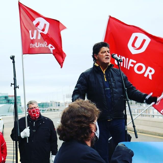 Jerry Dias speaking into a mic for a rally.