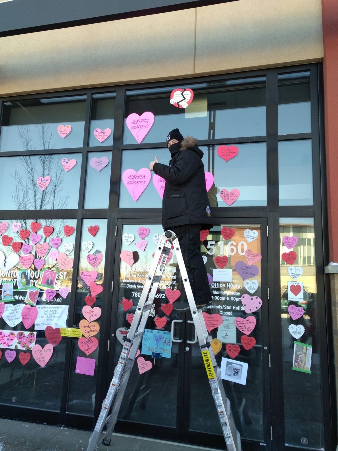 Unifor members take broken heart valentine messages to Alberta MLAs offices.