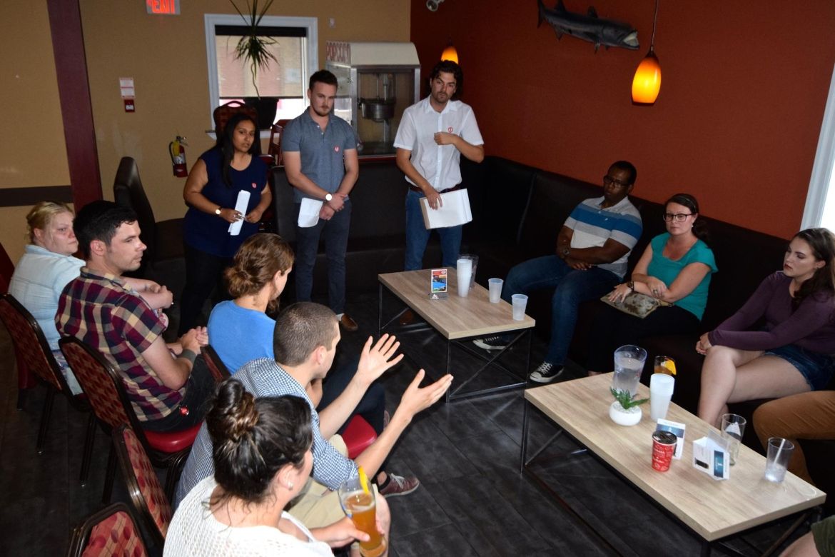 Young workers engage in discussion.