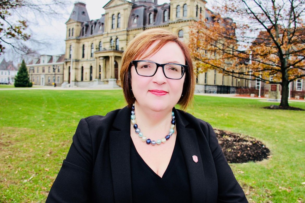 Lana Payne in front of the New Brunswick legislature.