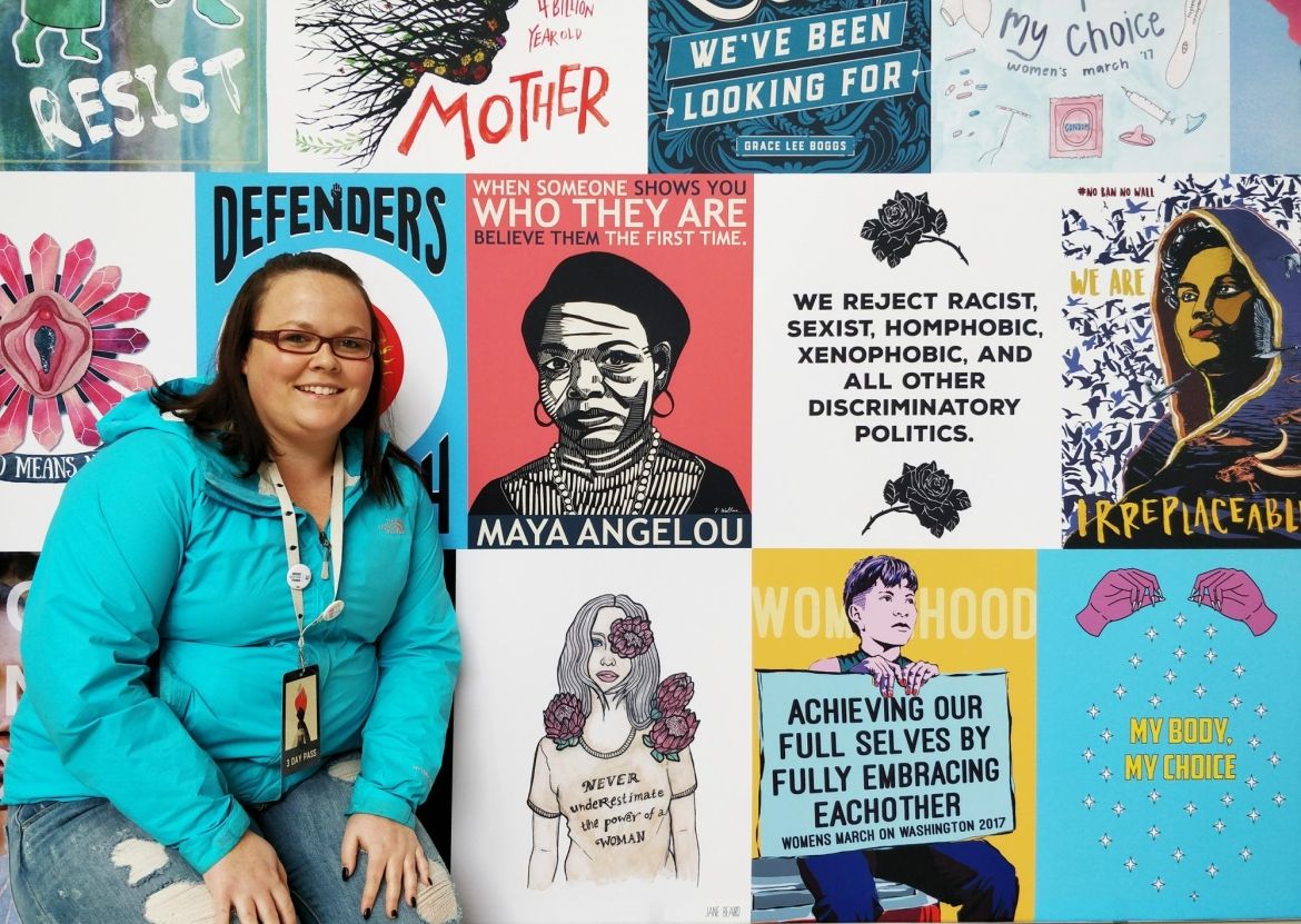 Jennifer Werrett of Unifor Local 649 poses in front of a large mural.
