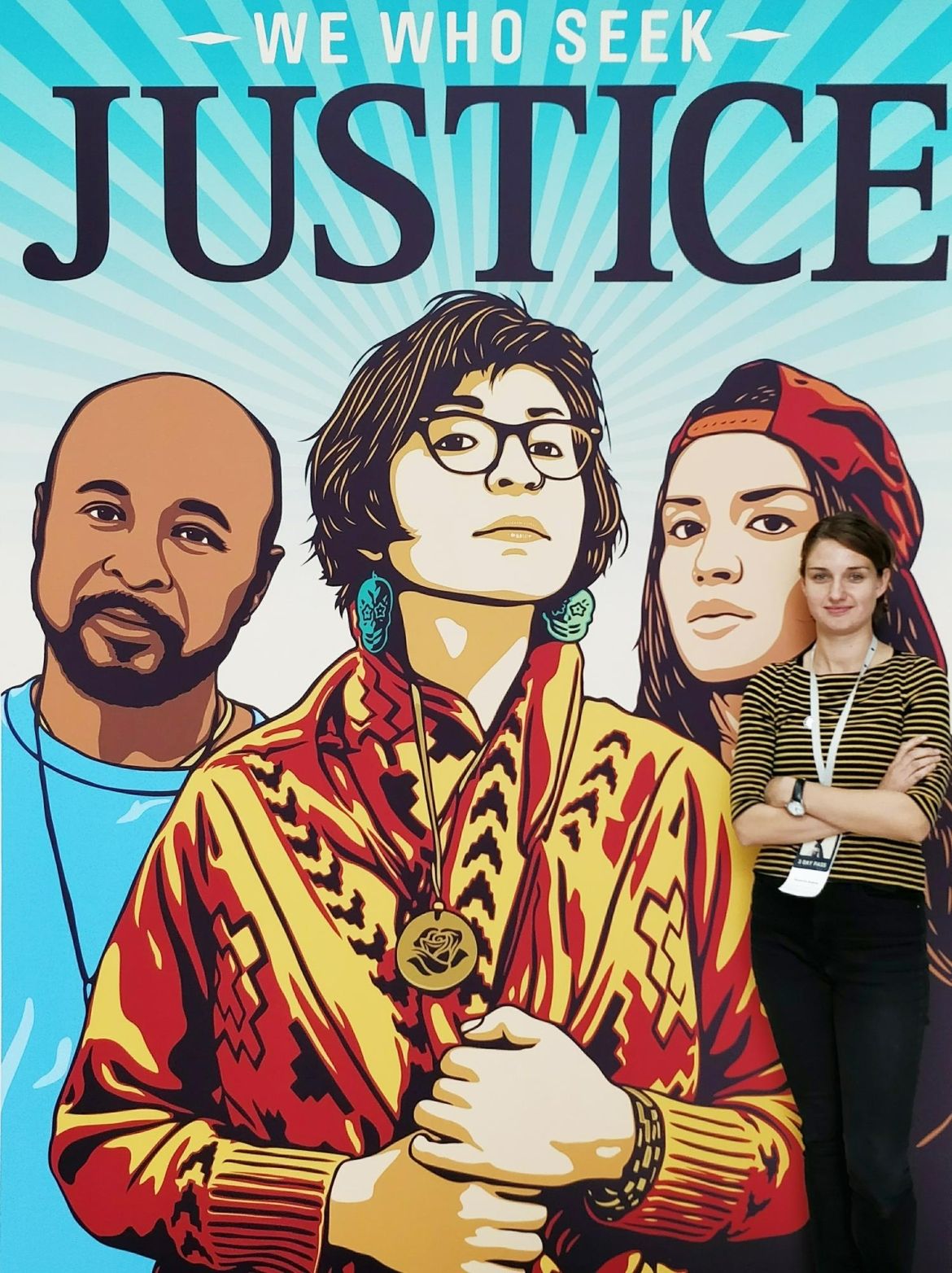 Roxanne Dubois poses in front of a large mural.