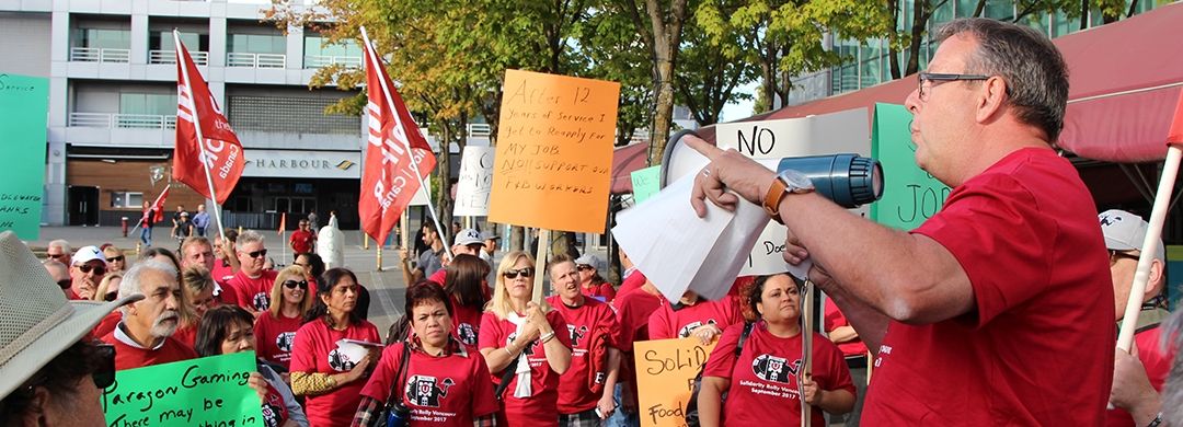 Bob Orr uses a megaphone to address Unifor members at a rally.