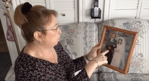 Sandy Lebeau points to her husband in their wedding photo.
