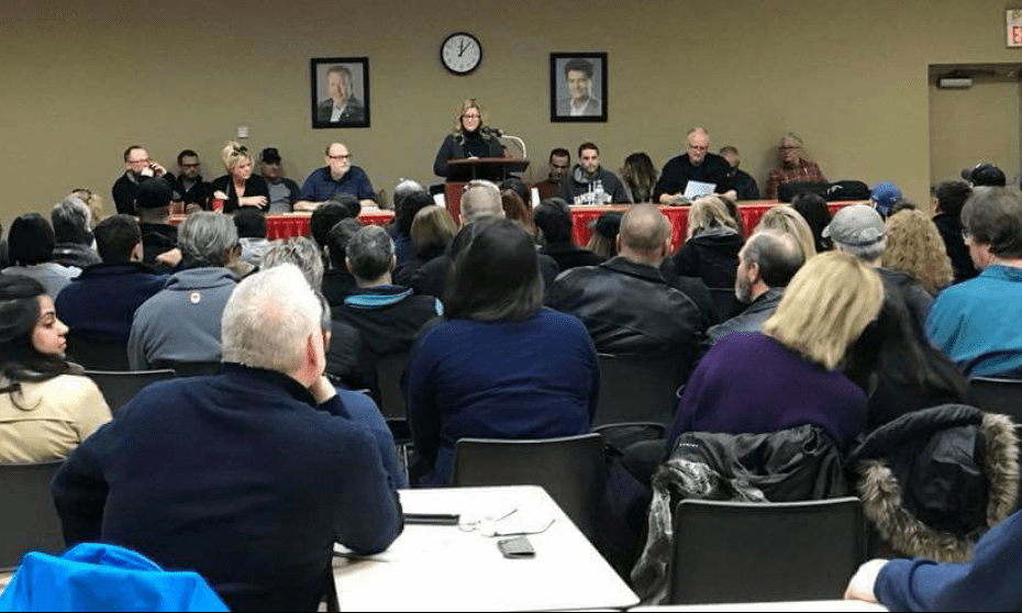 Members of Unifor locals 240 and 517-G fill a meeting hall as they listen to remarks from Julie Kotsis.