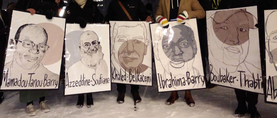 Activists hold images of Mamdou Tanou Barry, Azzeddine Soufiane, Khaled Melkacemi, Ibrahima Barry and Boubaker Thabti.
