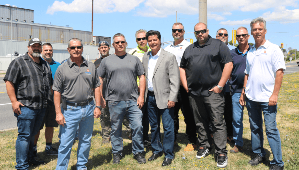 Jerry Dias stands with members of Local 222 outside an automotive production facility.