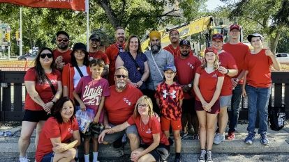 A group of people posing for a picture outside