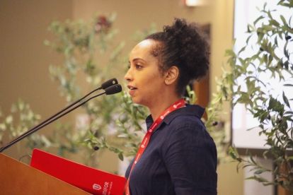 A women speaking at a podium