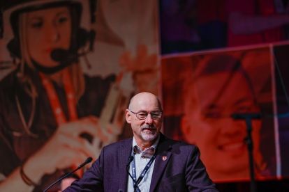 Len Poirier speaks at a podium.