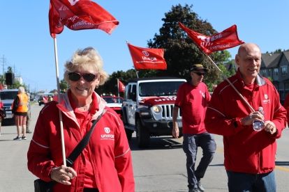 People marching down a street with flags