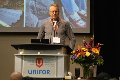a man speaks at a podium