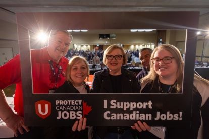 Lana at Podium with Protect Canadian Jobs selfie sign