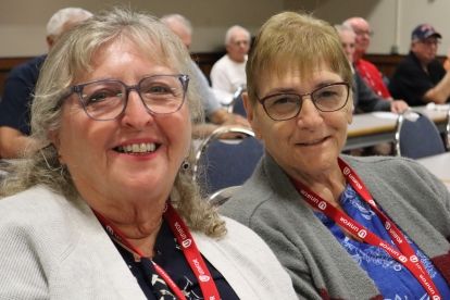 two women with glasses smiling