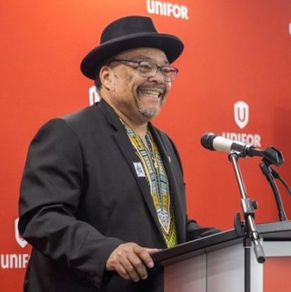 A man speaks at a podium.