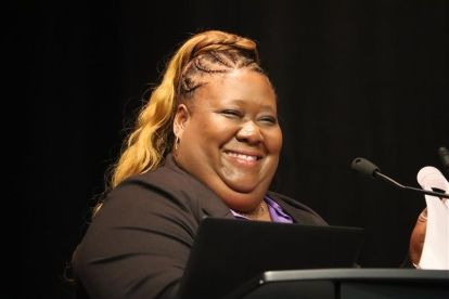 A women speaking at a mic.