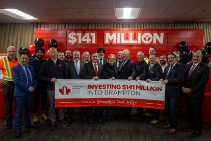 A large group standing in front of a banner