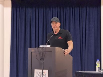 a man speaks at a podium