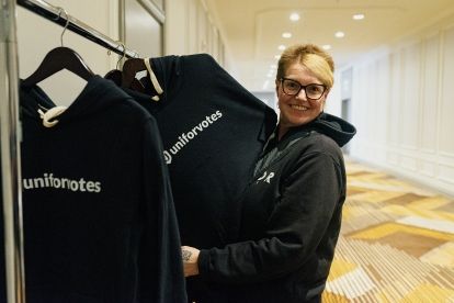 A women holding up a Unifor votes hooding from a coatrack