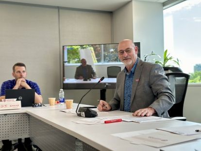 two people sitting at a table smiling