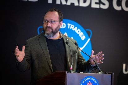A man speaks at a podium