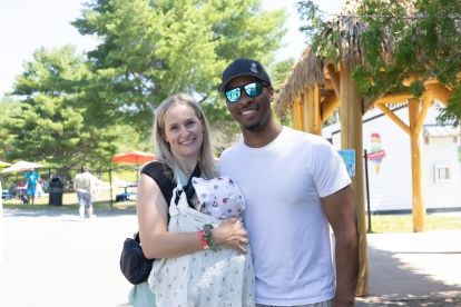 A couple holding a baby