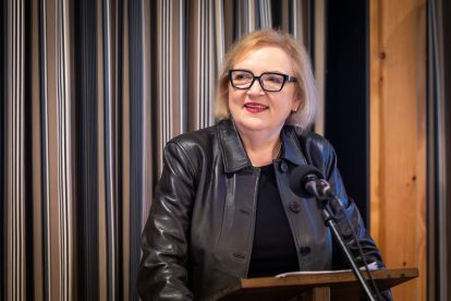 Lana Payne speaking at a podium
