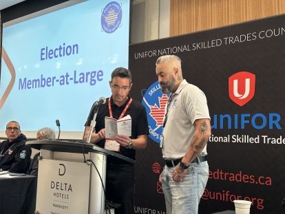 two men standing at a podium