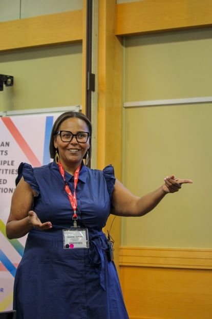 A  woman presenting at the front of a room