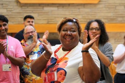 A woman smiling and clapping