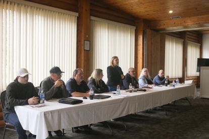 seven people sitting at a head table