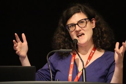 A women speaks at a mic