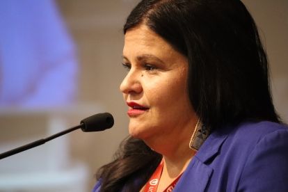 a women speaks at a mic