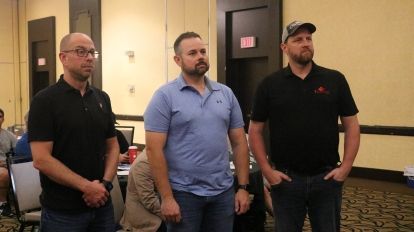 three men standing inside