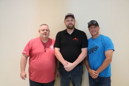 Three men standing together