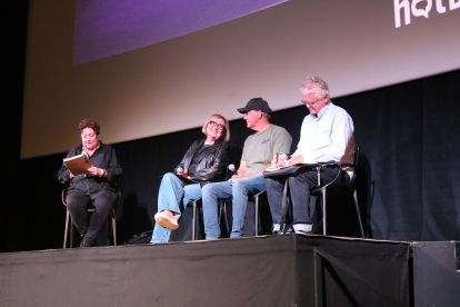 A four person pannel on a well lit stage
