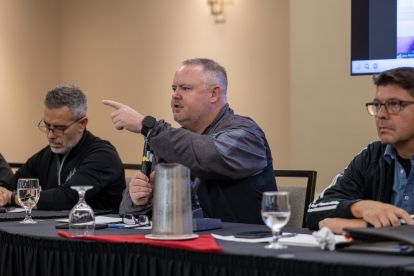 Man seated in front of a microphone
