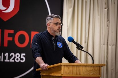 A man stands at a podium