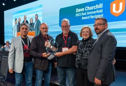 Group of Unifor executives posing with Dave Churchill and his Bud Jimmerfield award